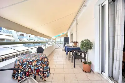 a balcony with a table and chairs on a building at Bright & Cosy in Athens! in Athens