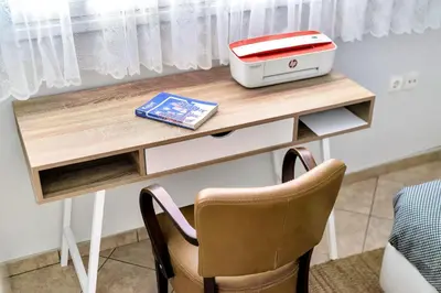 a desk with a printer on top of it at Bright & Cosy in Athens! in Athens