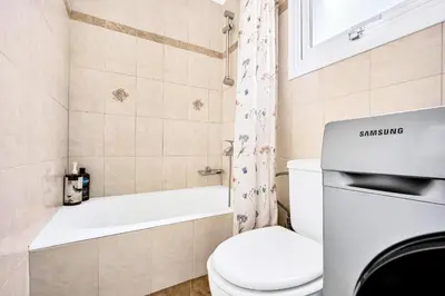 a small bathroom with a toilet and a bath tub at Bright & Cosy in Athens! in Athens