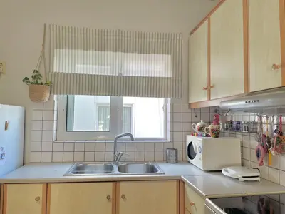 a kitchen with a sink and a microwave at Bright & Cosy in Athens! in Athens