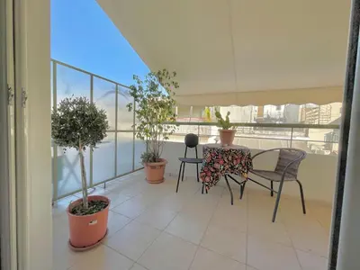 a balcony with a table and chairs and potted plants at Bright & Cosy in Athens! in Athens