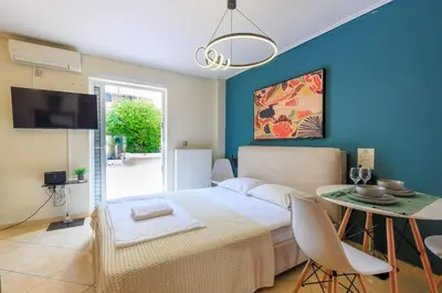 a bedroom with a bed and a table with a dining room at Aiolos GLYFADA super lux apartment in Athens