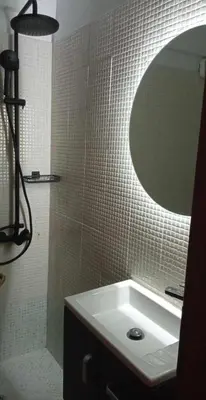 a bathroom with a sink and a mirror at Aiolos GLYFADA super lux apartment in Athens