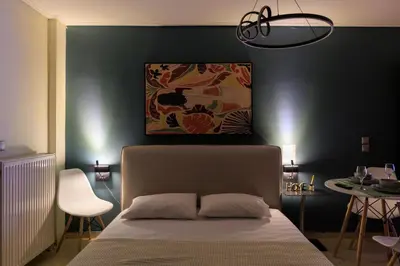 a bedroom with a bed and a black wall at Aiolos GLYFADA super lux apartment in Athens
