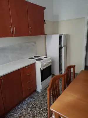 a kitchen with a stove and a table with chairs at Work, relax, enjoy - SHARED APARTMENT in Athens