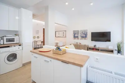 a kitchen with a washer and dryer and a living room at Athens central train station flat for 4 persons in Athens