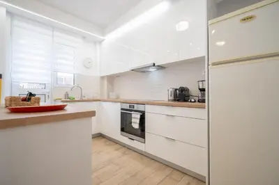 a kitchen with white cabinets and a refrigerator at Athens central train station flat for 4 persons in Athens