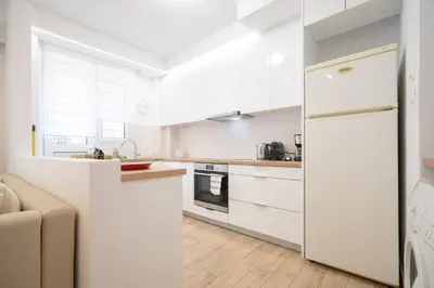 a kitchen with white cabinets and a refrigerator at Athens central train station flat for 4 persons in Athens