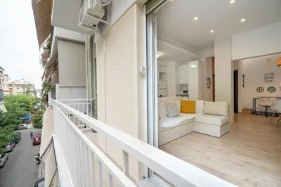 a balcony of a building with a white couch at Athens central train station flat for 4 persons in Athens
