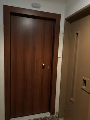 a wooden door in a room next to a hallway at Athens central train station flat for 4 persons in Athens