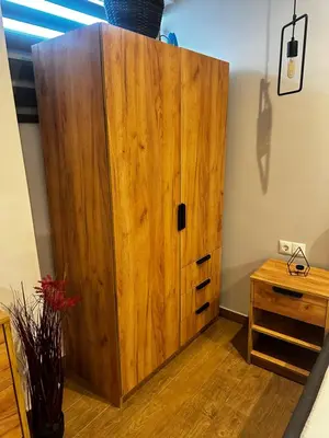 a large wooden cabinet in a room with a table at NEW COSY HOME KYPSELI ATHENS heart! in Athens