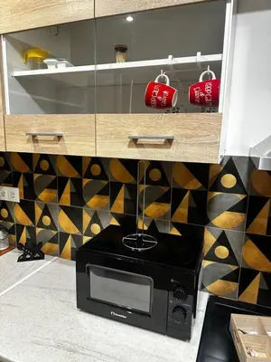 a microwave oven in a kitchen with a counter at NEW COSY HOME KYPSELI ATHENS heart! in Athens