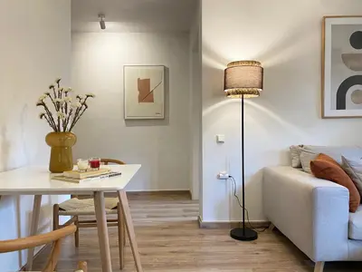 a living room with a table and a couch at Calm Cove One-Bedroom Home Glyfada in Athens