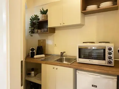a kitchen with a sink and a microwave on a counter at Calm Cove One-Bedroom Home Glyfada in Athens