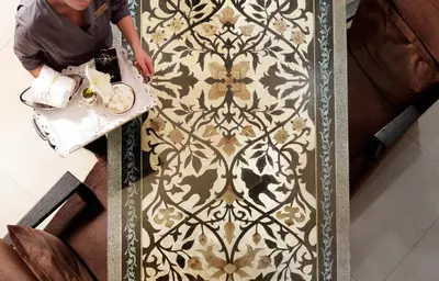 a person standing next to a stenciled wall at Divani Escape - Adults Only in Athens