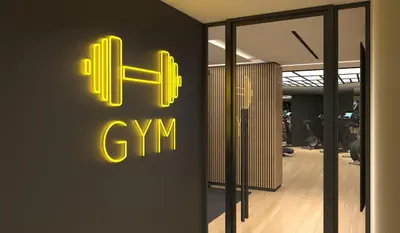 a gym sign on a wall in a room at Divani Escape - Adults Only in Athens