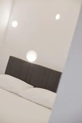 a couch in a white room with a light at Porto 118 New Reno Piraeus St near Marina Zeas, AC in Piraeus