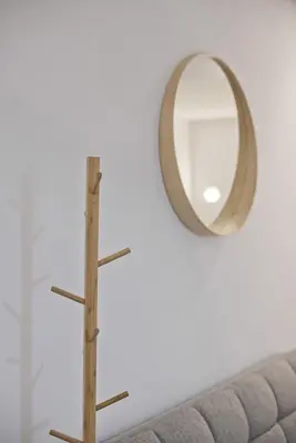 a mirror on a wall next to a couch at Porto 118 New Reno Piraeus St near Marina Zeas, AC in Piraeus