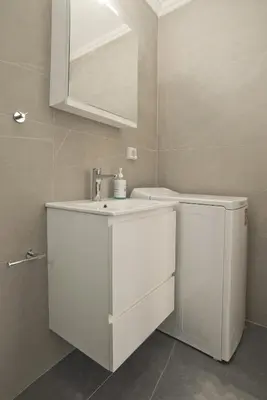 a white bathroom with a sink and a mirror at Porto 118 New Reno Piraeus St near Marina Zeas, AC in Piraeus