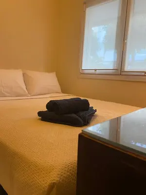 a bed with a towel on it in a bedroom at Cosy Lux Apartment in Athens
