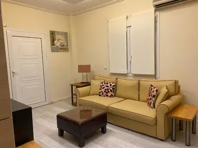 a living room with a couch and a table at Cosy Lux Apartment in Athens