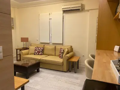 a living room with a couch and a table at Cosy Lux Apartment in Athens