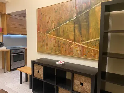 a kitchen with a large painting on the wall at Cosy Lux Apartment in Athens
