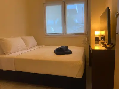 a bedroom with a bed and a window at Cosy Lux Apartment in Athens