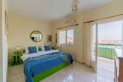 a bedroom with a bed and a large window at Amazing View Studio at Filopappou Hill in Koukaki! in Athens