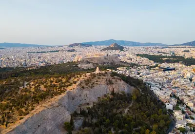 a view ofhenshenshenshenshens city from the top of a mountain at Amazing View Studio at Filopappou Hill in Koukaki! in Athens