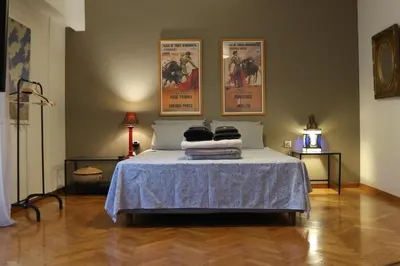 a bedroom with a bed with two posters on the wall at Central Apartment near Archeological Museum in Athens