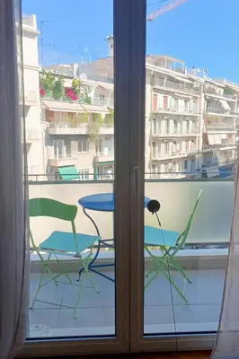 a window with two chairs and a table on a balcony at Central Apartment near Archeological Museum in Athens
