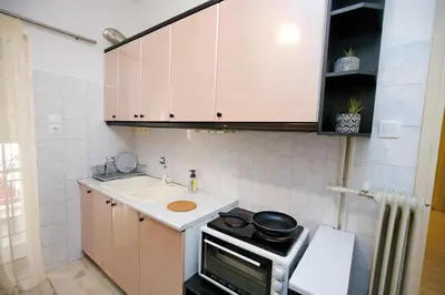 a small kitchen with a stove and a sink at Olga's Lovely Elia Apartment - Kaisariani in Athens