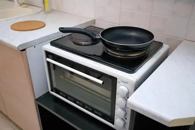 a frying pan on top of a stove in a kitchen at Olga's Lovely Elia Apartment - Kaisariani in Athens