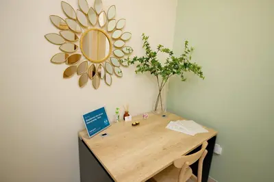 a wooden desk with a mirror on a wall at Olga's Lovely Elia Apartment - Kaisariani in Athens