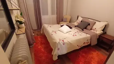 a bedroom with a bed with pink flowers on it at Ισόγειο διαμέρισμα με υπαίθριο χώρο in Athens