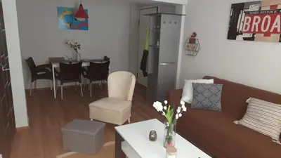 a living room with a couch and a table at Ισόγειο διαμέρισμα με υπαίθριο χώρο in Athens