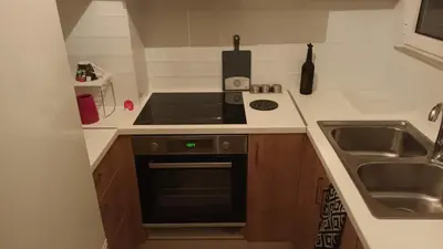 a small kitchen with a stove and a sink at Ισόγειο διαμέρισμα με υπαίθριο χώρο in Athens