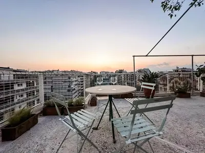 a table and chairs on the roof of a building at Beach rooftop Athens Riviera in Athens