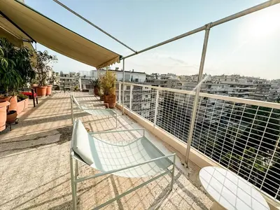 a balcony with chairs and a view of a city at Beach rooftop Athens Riviera in Athens