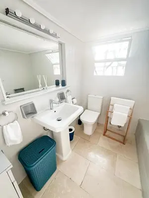 a bathroom with a sink and a toilet and a mirror at Beach rooftop Athens Riviera in Athens
