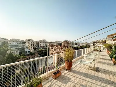 a balcony with plants and a view of a city at Beach rooftop Athens Riviera in Athens