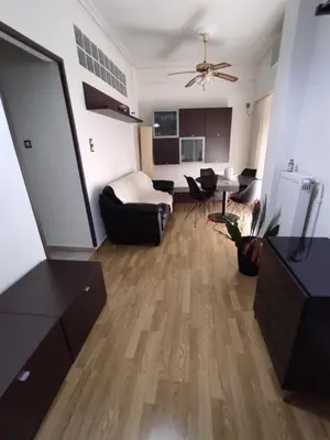 a living room with a couch and a table at Cosy apartment on Dragon street in Athens