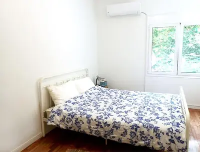 a bedroom with a bed with a blue and white comforter at Athens Pangrati cute apt, 15 mins from metro in Athens