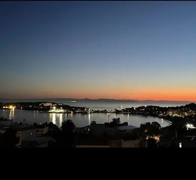 a view of a body of water at night at Vouliagmeni Panoramic 200m2 Rooftop & 25m2 Loft in Athens