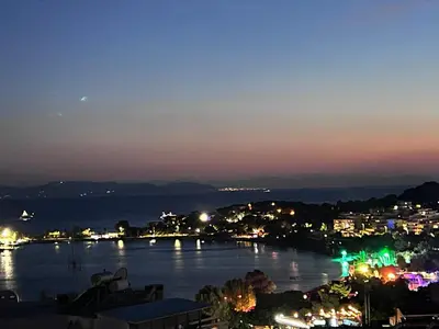 a view of a river at night with a city at Vouliagmeni Panoramic 200m2 Rooftop & 25m2 Loft in Athens