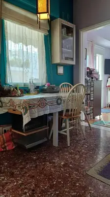 a kitchen with a table and chairs in a room at cozy διαμέρισμα με υπέροχη θέα ! in Athens