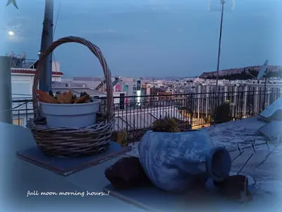 a basket of fruit on a balcony with a view of a city at cozy διαμέρισμα με υπέροχη θέα ! in Athens
