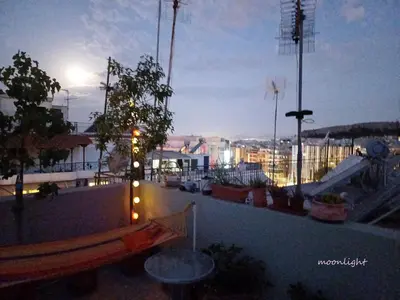 a rooftop with lights and a view of a city at cozy διαμέρισμα με υπέροχη θέα ! in Athens