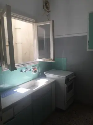 a small kitchen with a sink and a window at Simple & Spacious - Shared Accomodation in Athens